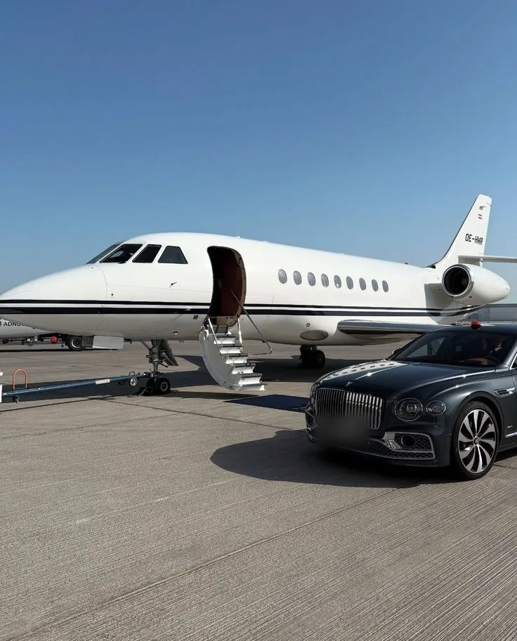 Bentley Flying Spur beside a private jet