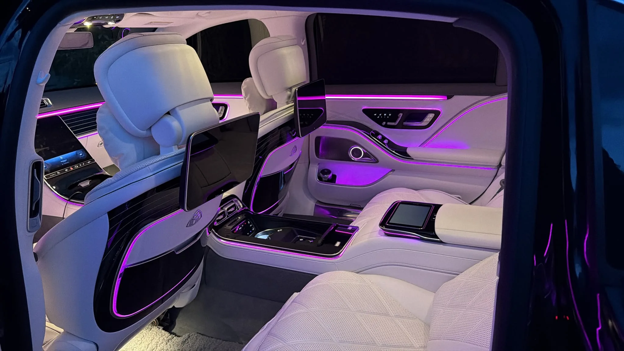 Rear cabin of a Mercedes-Maybach with white leather
